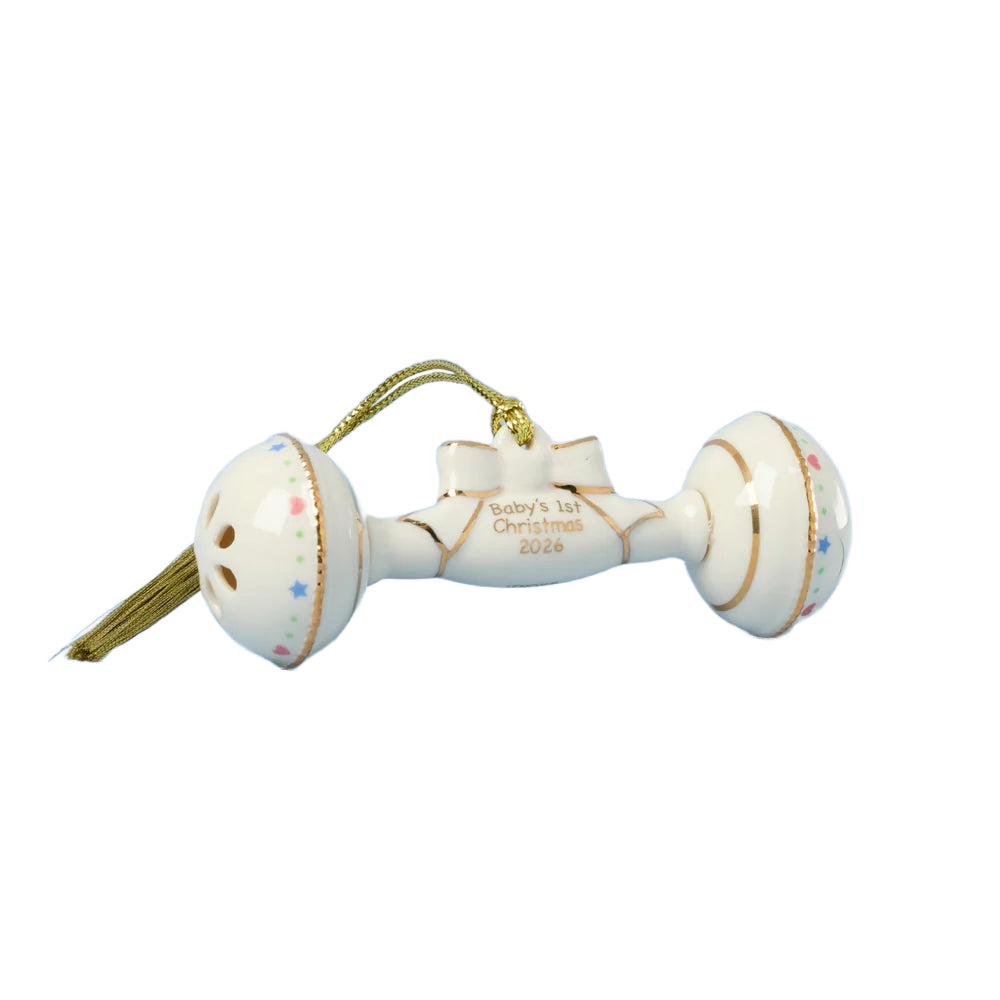 Multicolored baby rattle ornament with "Baby's 1st Christmas 2026" written in gold on it, shown on a white background