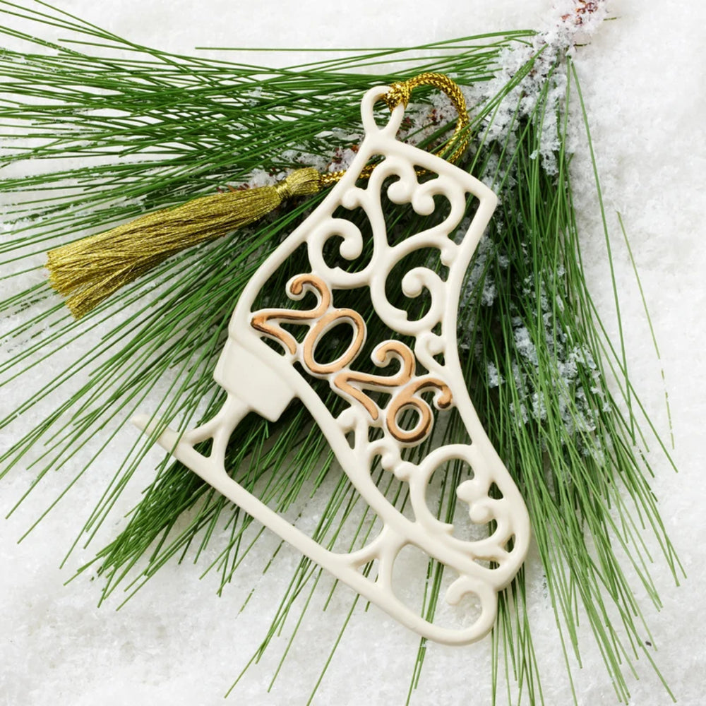 Decorative Christmas ornament with '2021' on a branch with snow