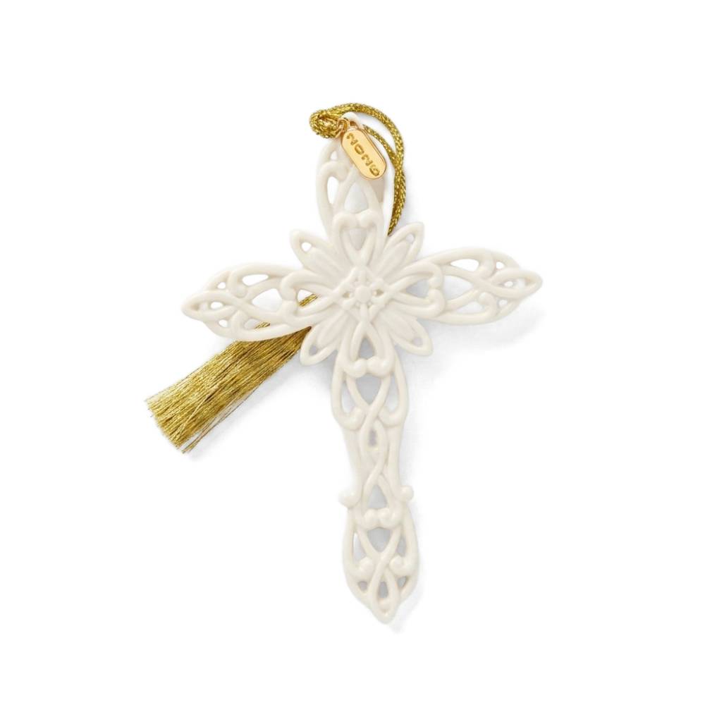 An off-white ceramic cross ornament with intricate cutout detailing, a gold hanging loop, and a gold tassel, shown on a plain white background.