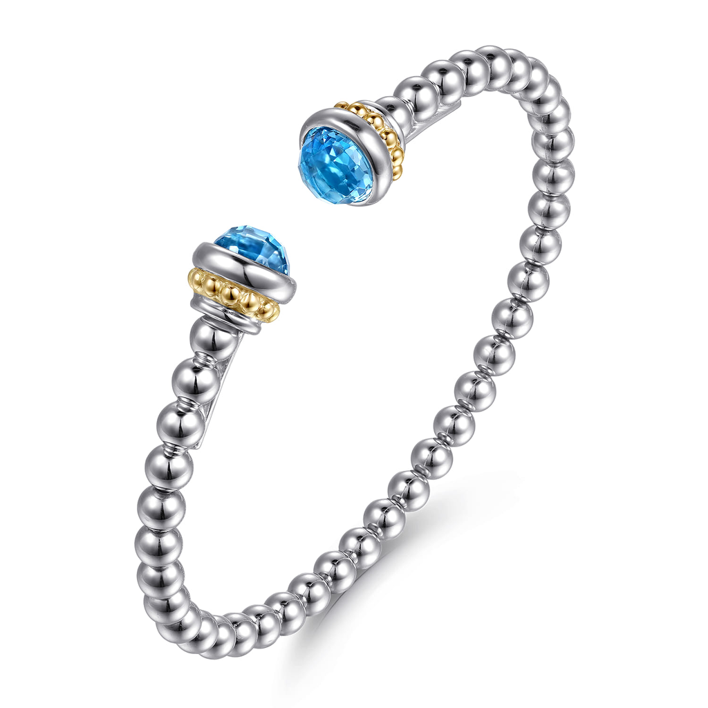 Silver beaded ring with blue gemstones on a white background