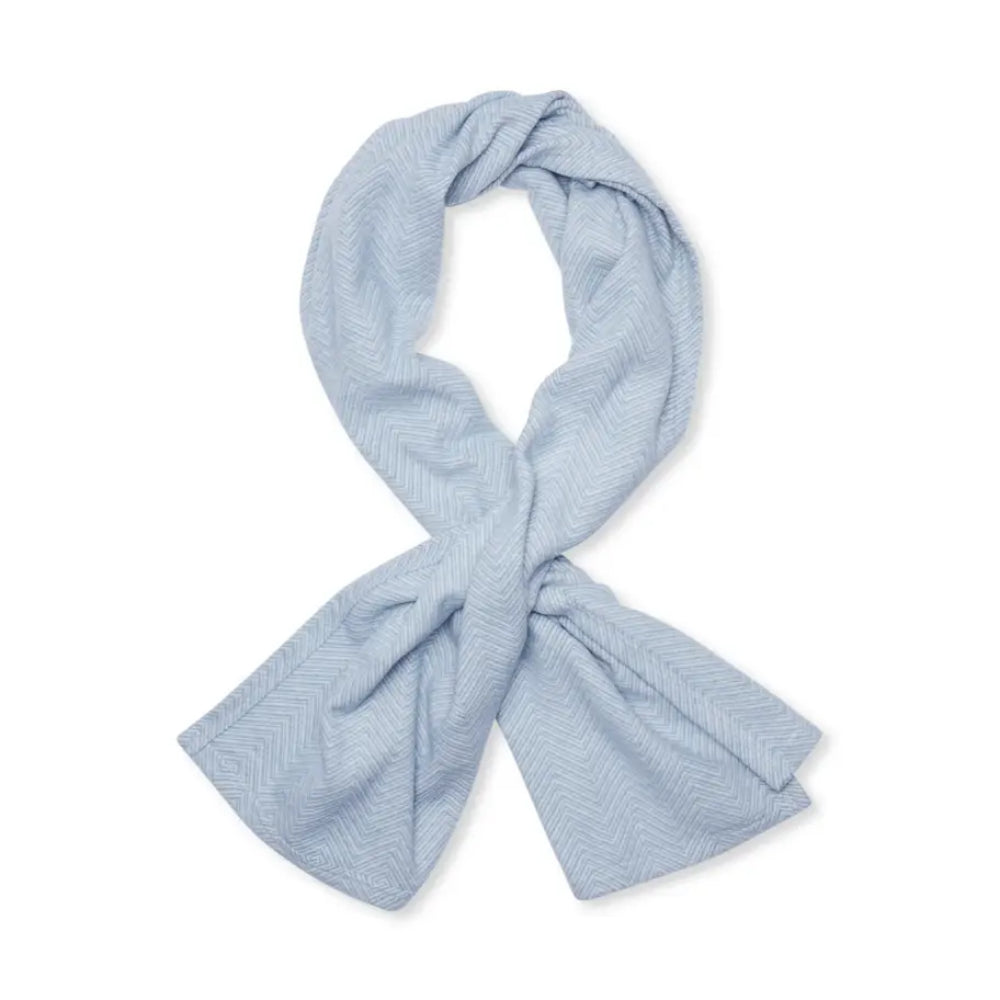 A light blue shawl with a fine herringbone pattern, styled in a loop with a knot at the bottom, shown on a plain white background.