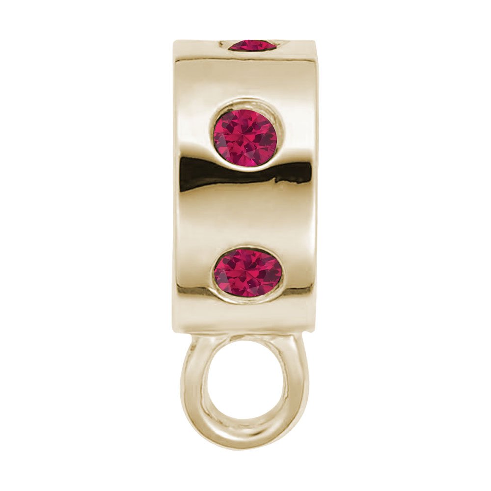 Gold charmdrop with red stones on a white background