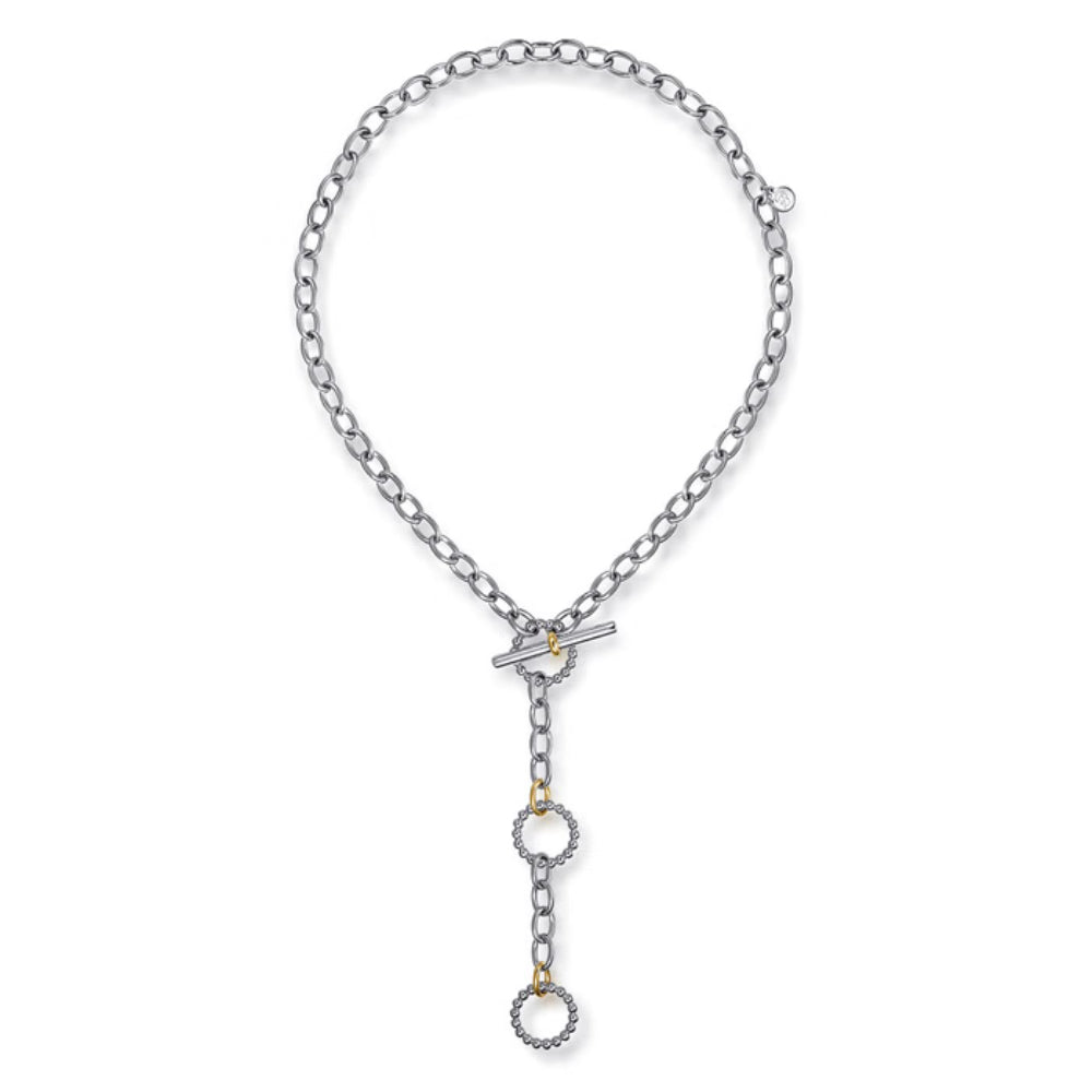 A silver-toned chain necklace with a toggle clasp and three dangling circular links, some accented with small gold details, shown on a plain white background.