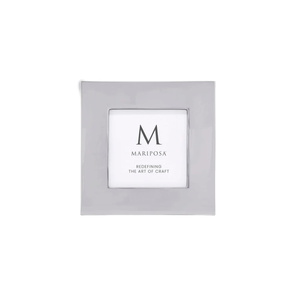 A square silver picture frame with a white insert card displaying the brand name 'MARIPOSA' and a large monogram 'M'.