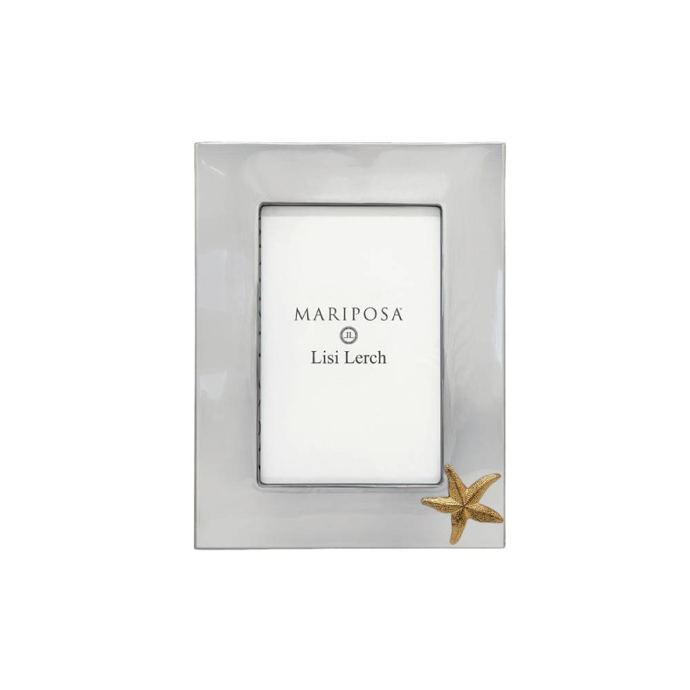A rectangular silver picture frame with a small gold starfish accent in the bottom right corner, shown on a plain white background. The insert card displays the brand name 'MARIPOSA' and designer 'Lisi Lerch'.