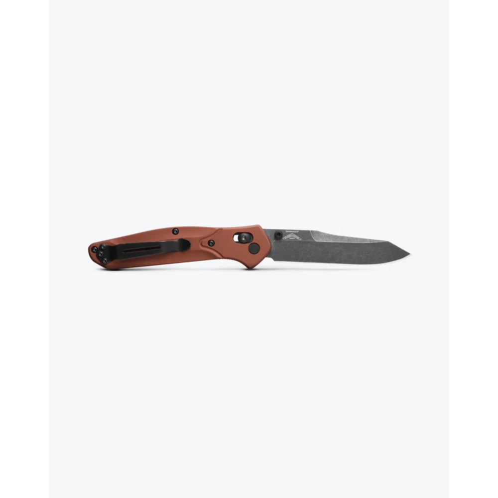 Folding knife with brown handle and black blade on a white background