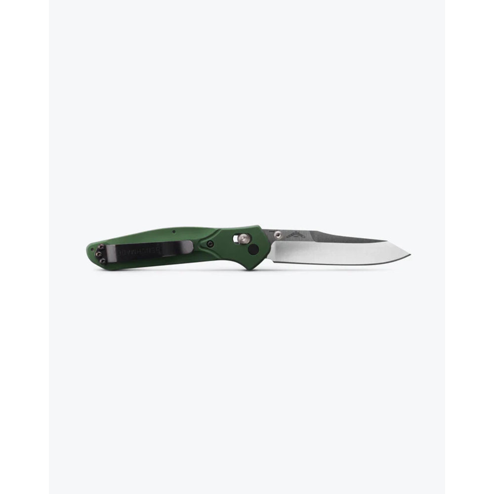 Folding knife with green handle on a white background