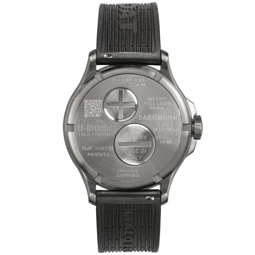 The back view of a U-Boat Darkmoon smartwatch with a dark gray metallic case and a textured black strap, showing the battery compartment and engraved details.