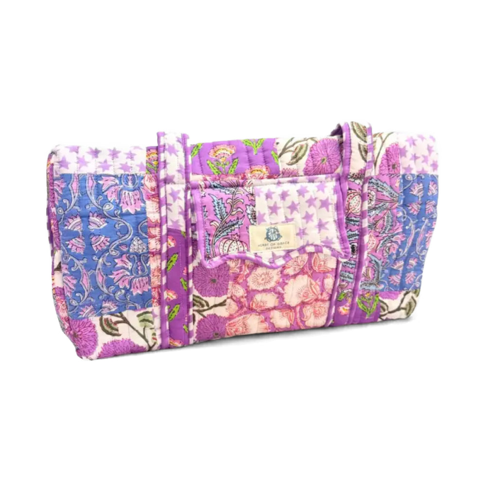 Heart of Grace quilted multi-color and pattern bag on a white background