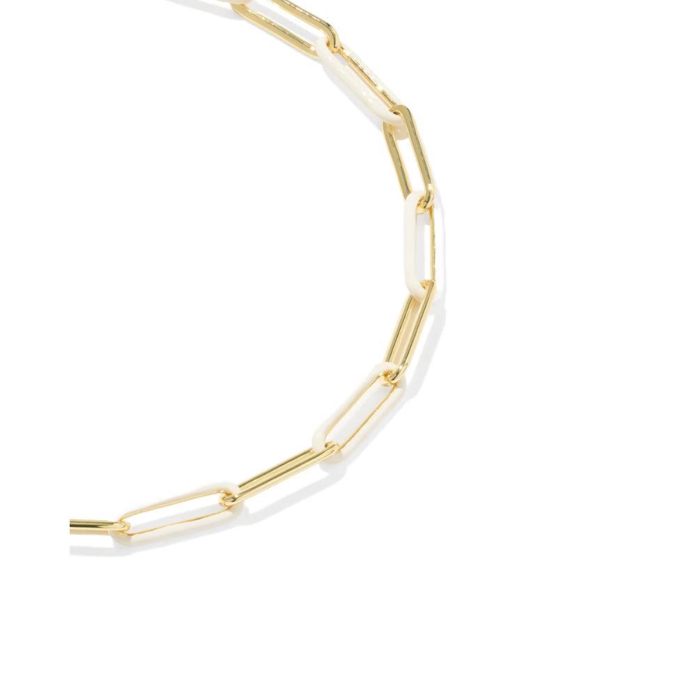 A close-up of a gold paperclip chain necklace on a clean white background.