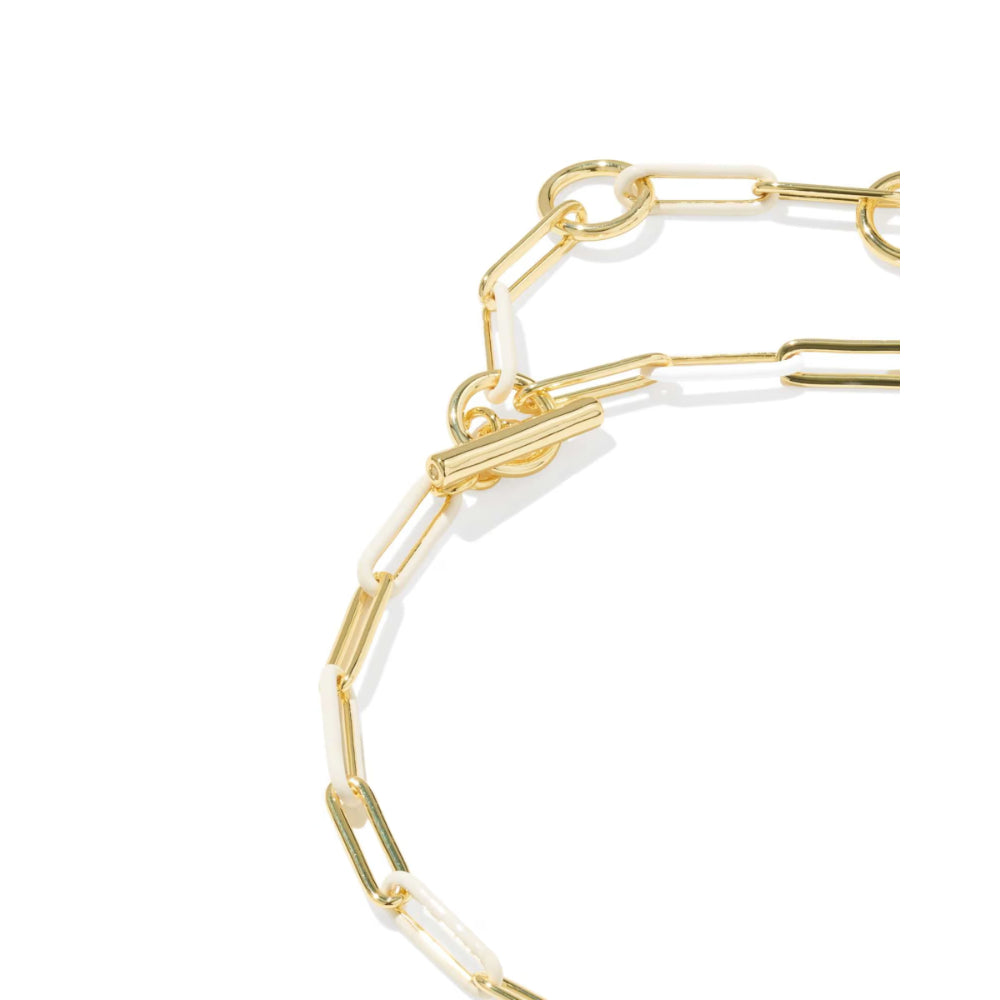 A close-up of a gold paperclip chain necklace on a clean white background.