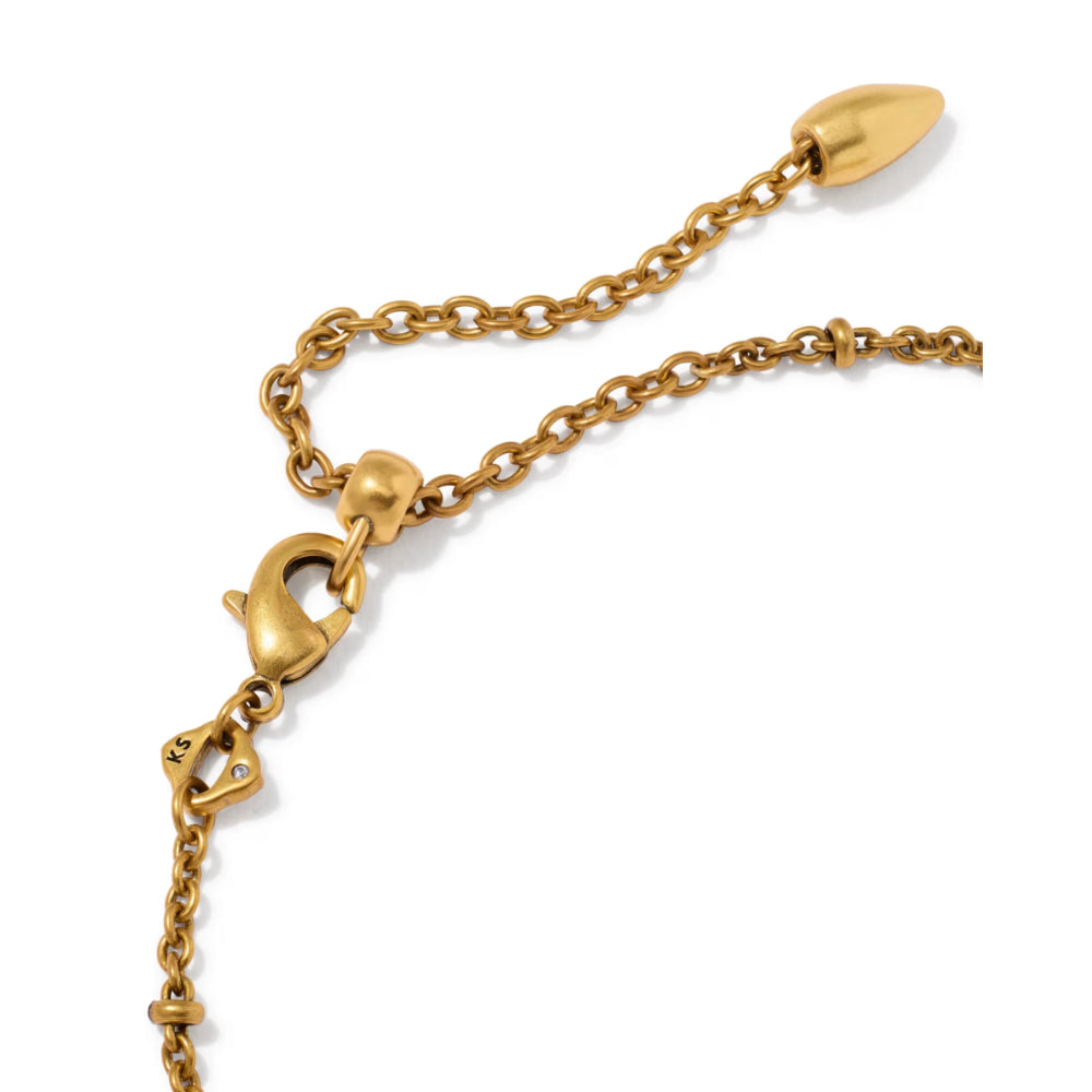 A close-up of a gold-toned chain necklace with a lobster clasp, extender chain, and teardrop-shaped bead on a plain white background.