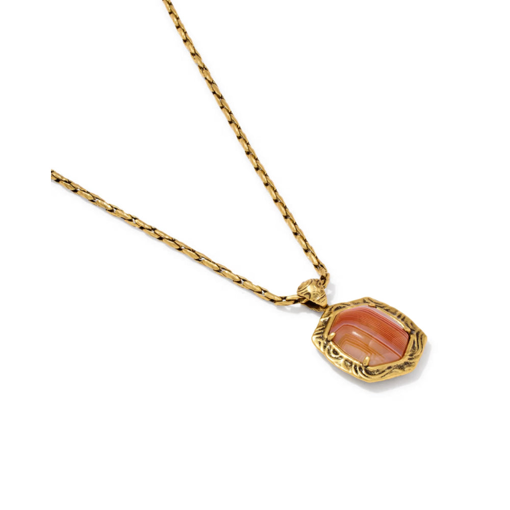 A gold chain necklace with a textured, scalloped gold bezel holding a polished peach-orange cabochon gemstone, shown on a plain white background.