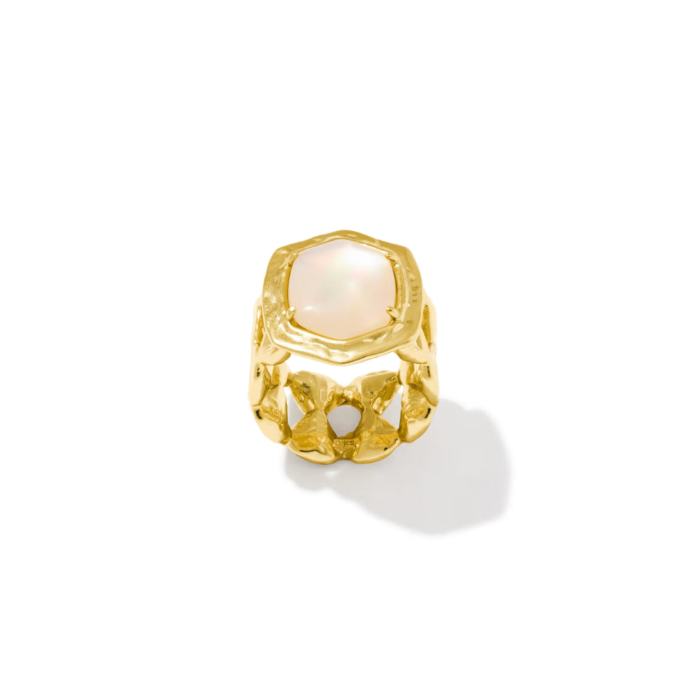 A gold ring featuring a large, irregularly shaped pale pink mother-of-pearl cabochon stone, set against a clean white background with a soft shadow.