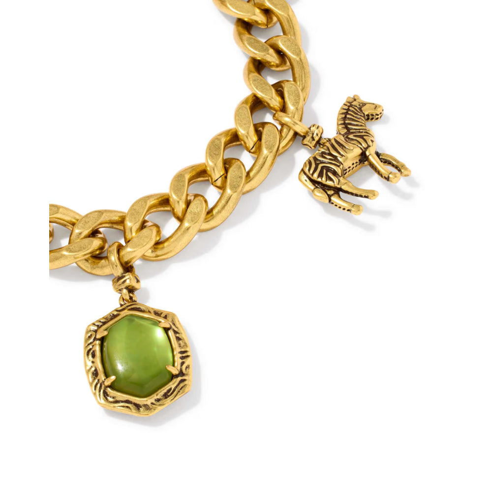 A gold-tone chain bracelet featuring a green cabochon gemstone pendant and a small horse charm, shown on a clean white background.
