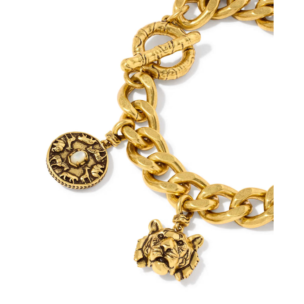 Gold-tone chain bracelet featuring a round medallion charm and a tiger head charm, displayed on a clean white background.