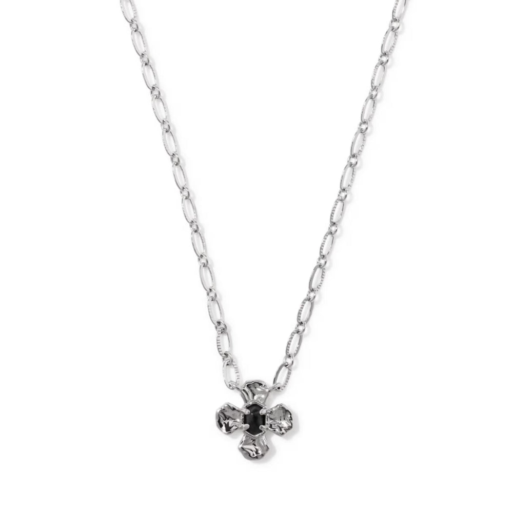A silver chain necklace with a small four-petal flower pendant featuring a dark center and clear faceted stones, shown on a plain white background.