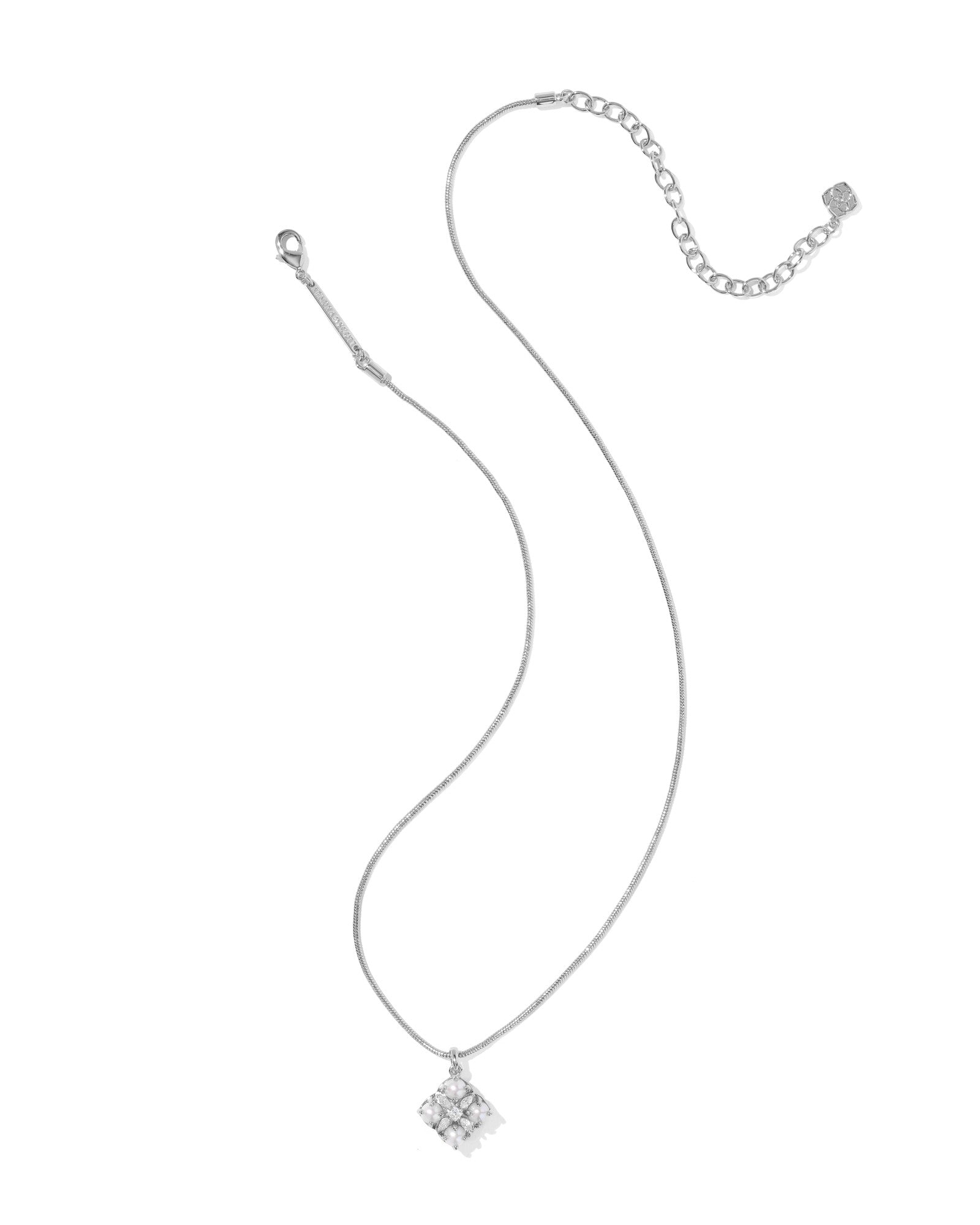 Gold necklace with a small pendant on a white background