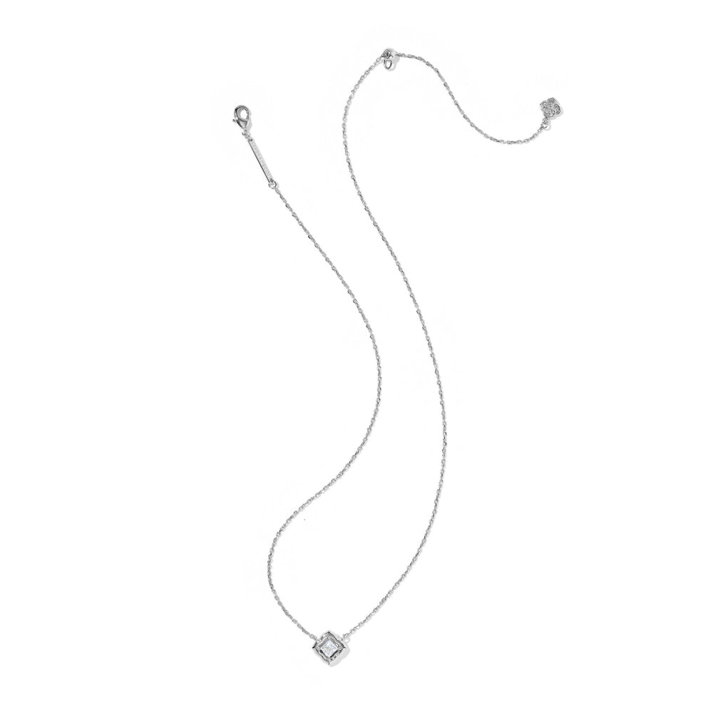 A delicate silver chain necklace featuring a square bezel-set clear gemstone pendant, displayed on a solid white background.