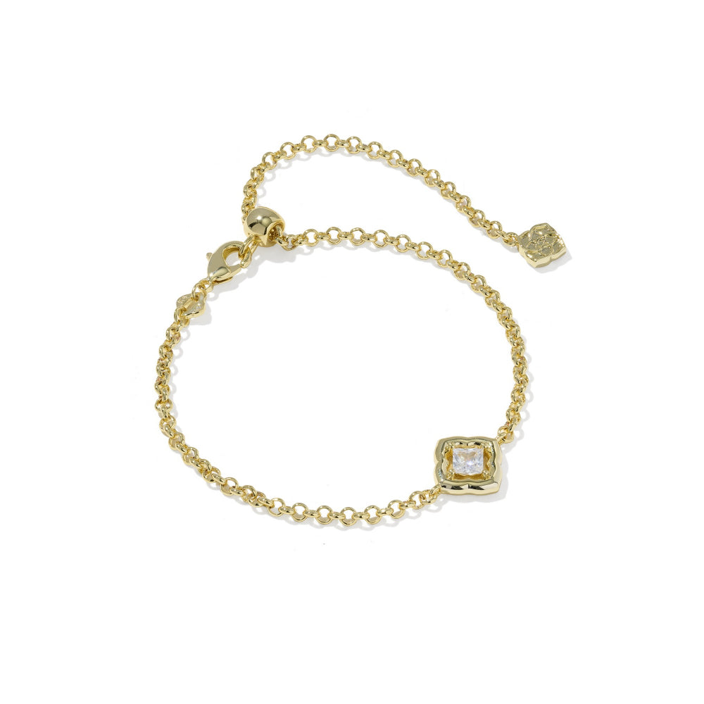 A delicate yellow gold chain bracelet with a square bezel-set clear gemstone and an adjustable extender chain with a small heart charm, shown on a plain white background.