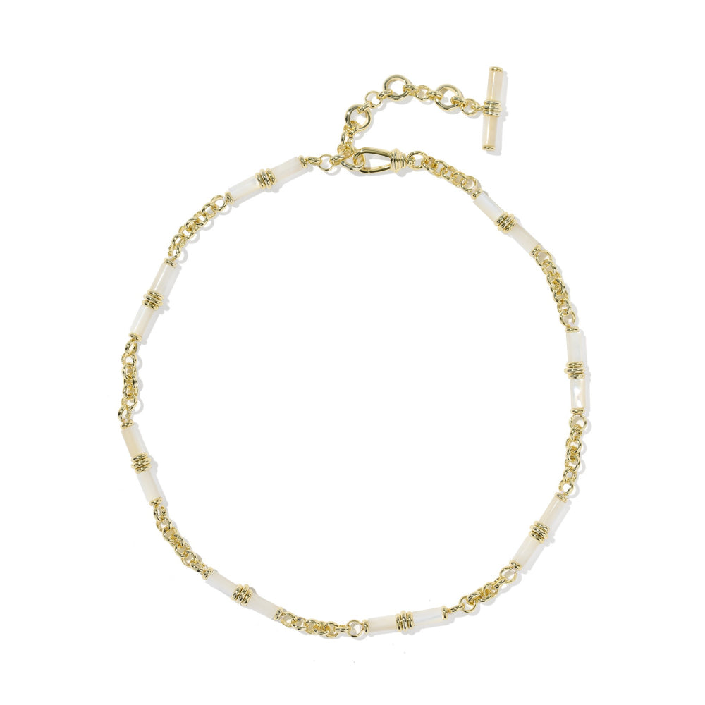A delicate gold chain necklace with alternating white cylindrical beads and small gold spacer details, featuring a gold clasp and extender chain with a toggle clasp, shown on a plain white background.