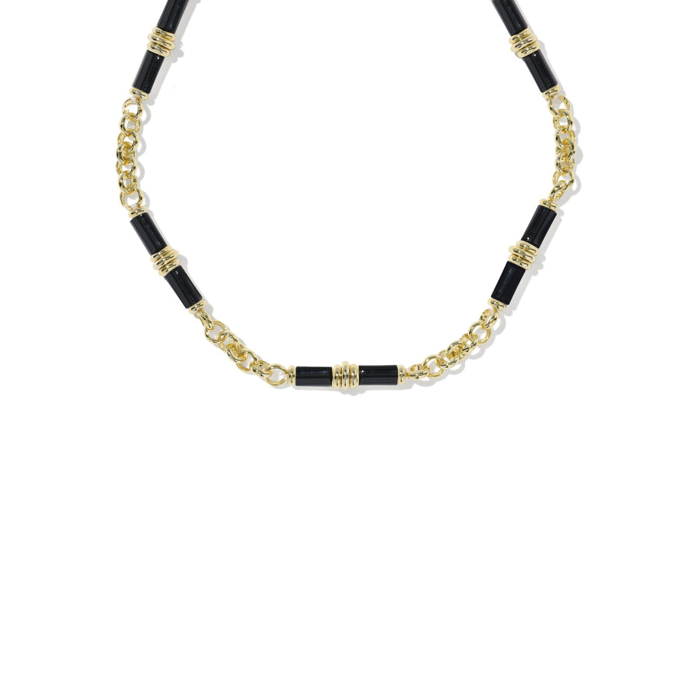 A gold and black beaded necklace featuring cylindrical black beads alternating with gold chain links and textured gold spacer rings, displayed on a clean white background.