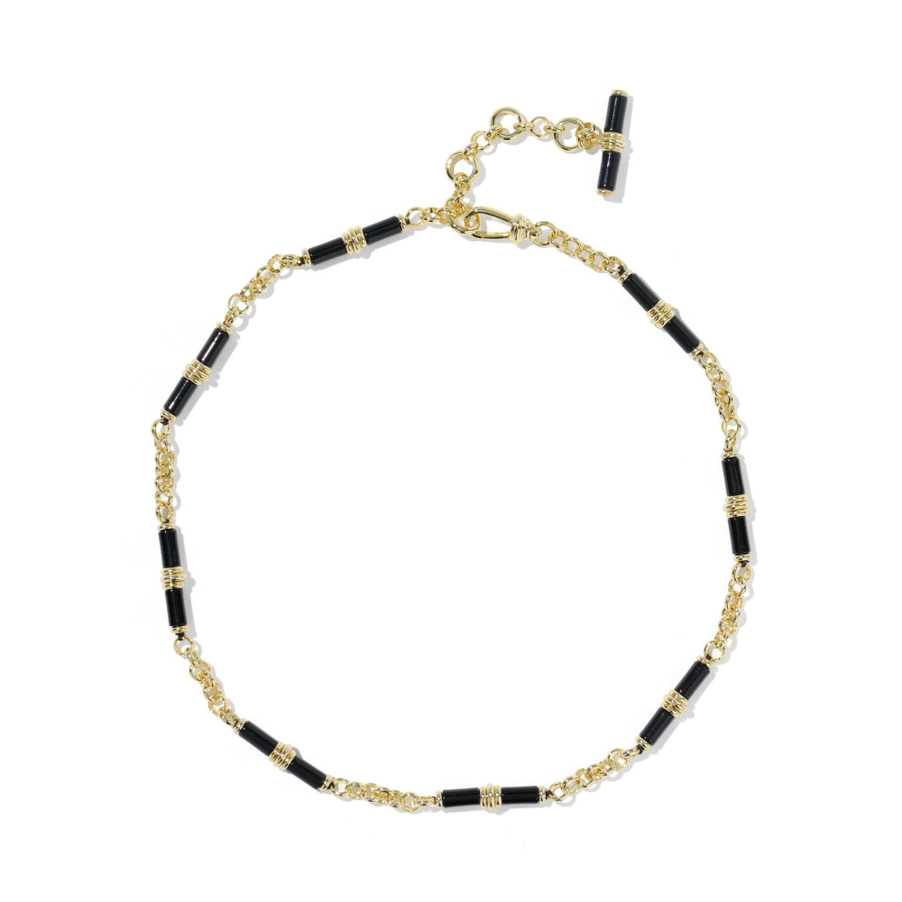 A gold chain bracelet with alternating black cylindrical beads and small gold spacer rings, featuring a lobster clasp and a T-bar toggle closure, shown on a plain white background.