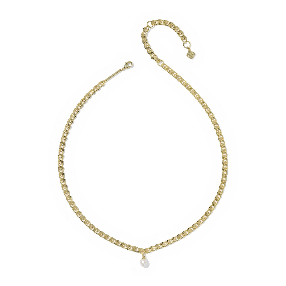 A delicate gold chain necklace with a small teardrop-shaped clear stone pendant, displayed on a clean white background.