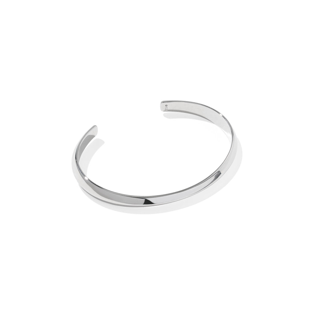 A polished silver-tone open cuff bracelet, also known as a bangle, shown on a clean white background with a soft shadow.
