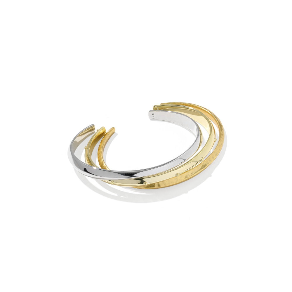 A tri-tone metal cuff bracelet featuring interlocking curved bands of polished yellow gold and silver-tone metal, displayed on a clean white background with a soft shadow.