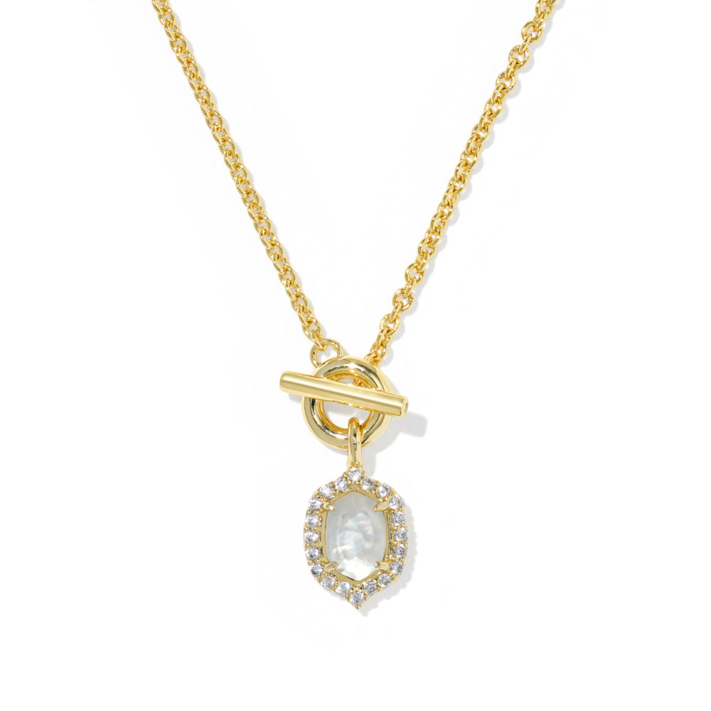 A gold chain necklace with a toggle clasp and a teardrop-shaped pendant featuring a central white stone surrounded by a halo of small clear stones, shown on a white background.