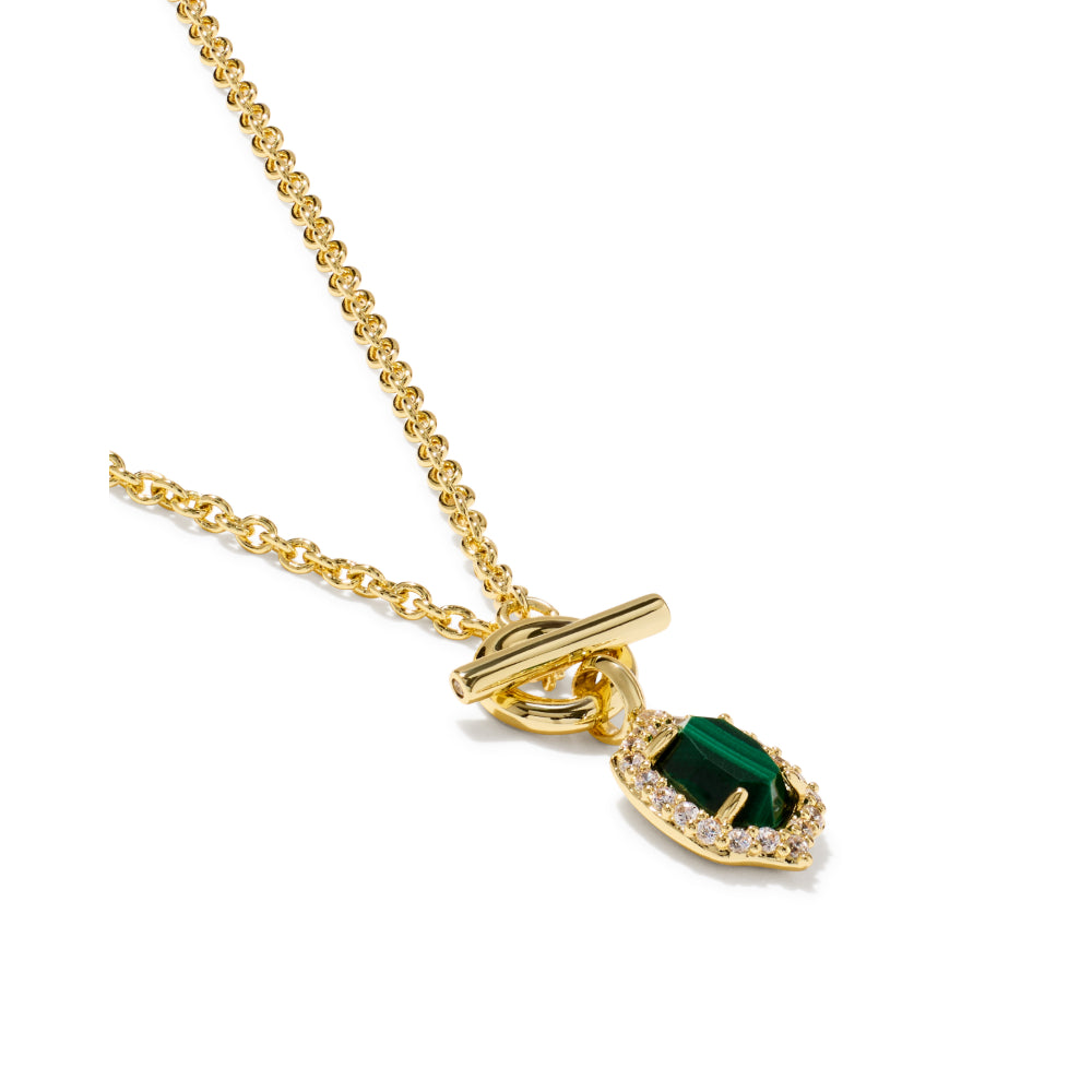 A gold chain necklace with a toggle clasp and a teardrop-shaped green gemstone pendant surrounded by small clear stones, shown on a plain white background.