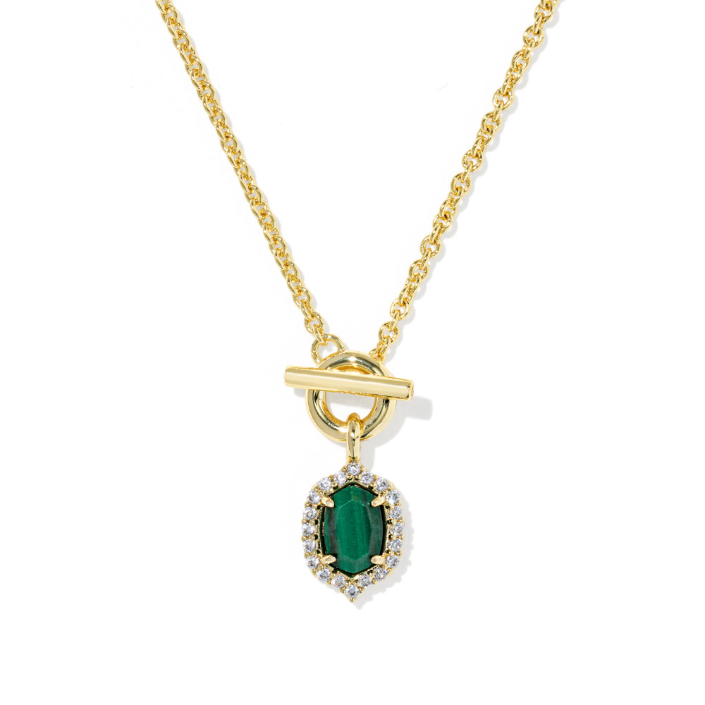 A gold chain necklace with a toggle clasp and a pendant featuring a green emerald-cut center stone surrounded by small clear stones, shown on a white background.