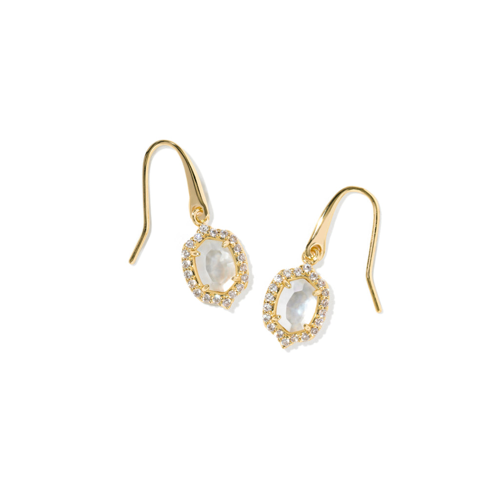 A pair of gold dangle earrings featuring oval milky white stones surrounded by small clear stones, set against a plain white background.