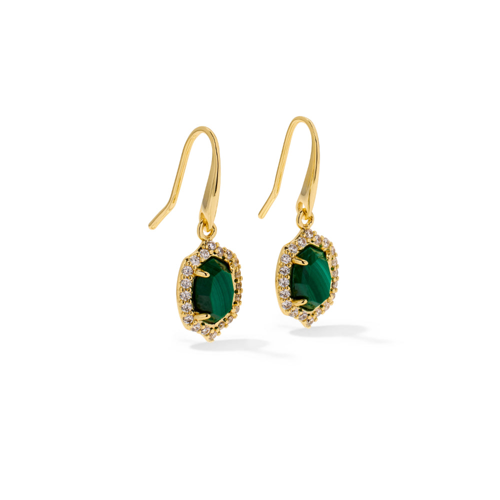 A pair of gold drop earrings featuring oval-cut emerald green stones surrounded by a halo of small clear stones, shown on a clean white background.