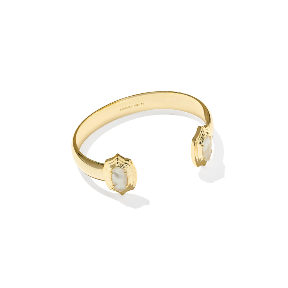 A gold cuff bracelet with two shield-shaped bezel settings holding white marquise-cut gemstones, shown on a clean white background with a soft shadow.