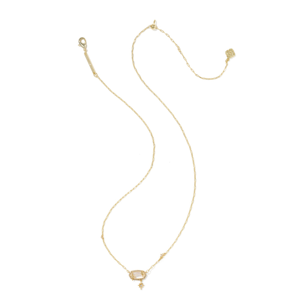 A delicate gold chain necklace featuring a small oval pale pink stone pendant and a tiny dangling gold charm, displayed on a clean white background.