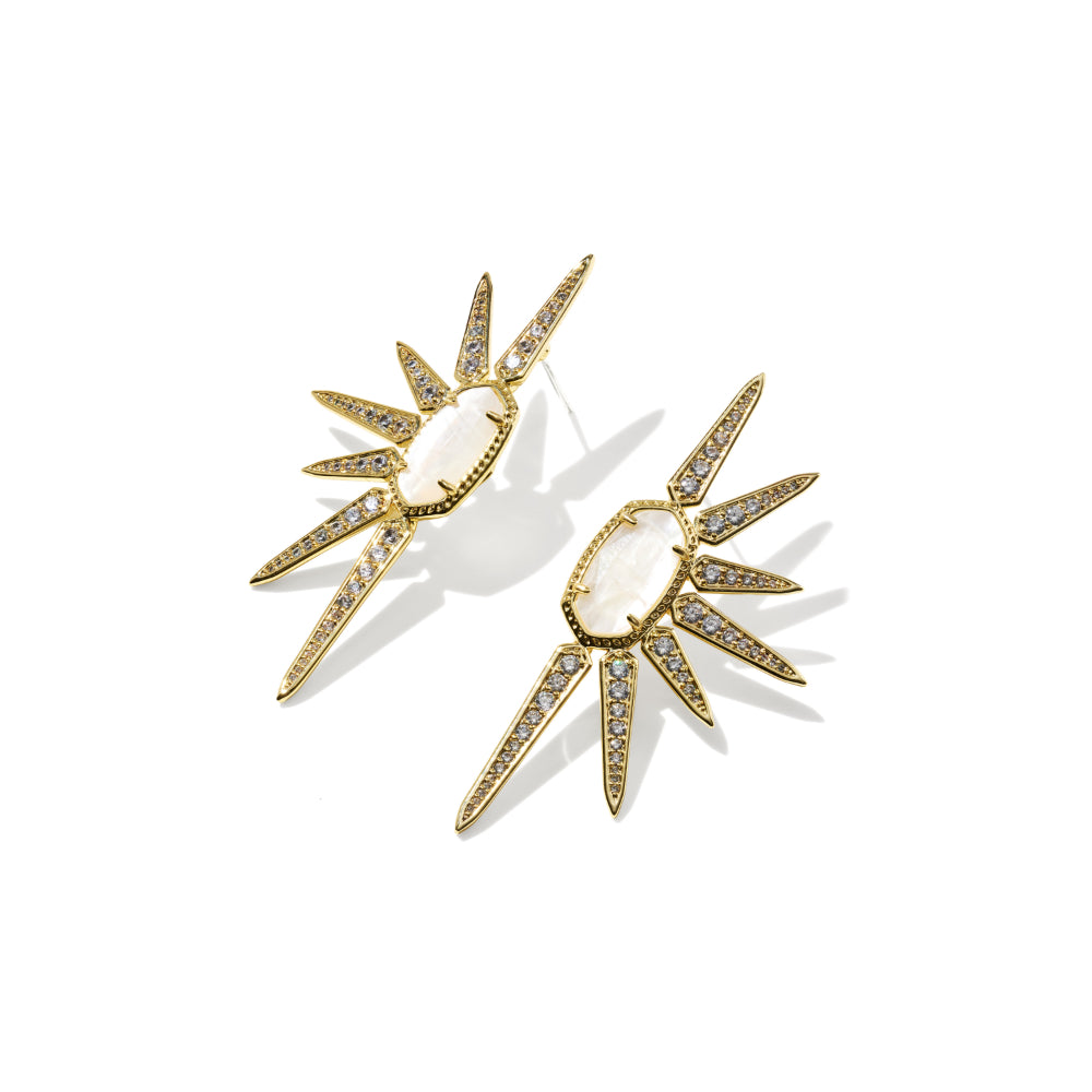 A pair of gold-toned statement earrings featuring oval milky white center stones and multiple pointed starburst spikes paved with small clear stones, shown on a clean white background.