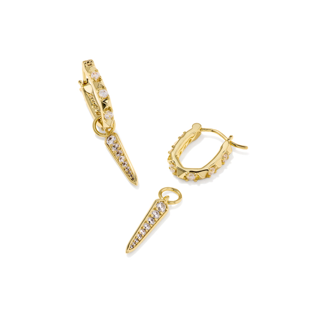Gold huggie hoop earrings with small clear stones and matching gold spike drop charms, shown on a clean white background.