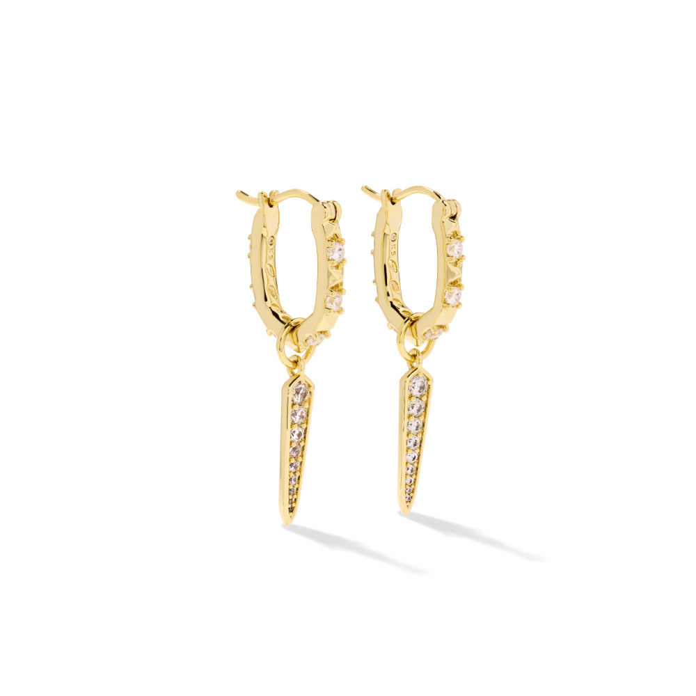 A pair of gold hoop earrings with small clear stones set along the front and a matching gold spike dangle charm, shown on a clean white background.