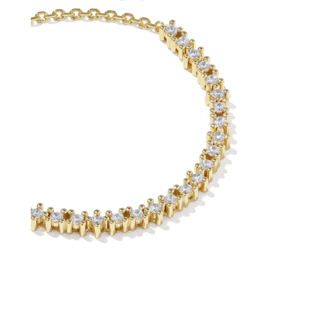 A gold tennis bracelet featuring round clear gemstones in a prong setting, arranged in a curved line on a white background.