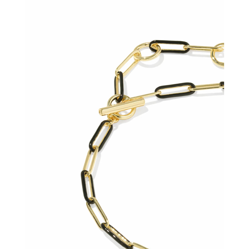 A close-up of a gold chain necklace featuring alternating polished gold and matte black paperclip-style links, with a gold toggle clasp, shown on a plain white background.