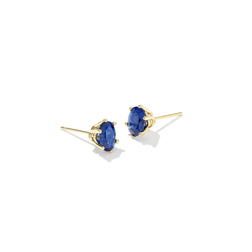 Gold earrings with blue gemstones on a white background