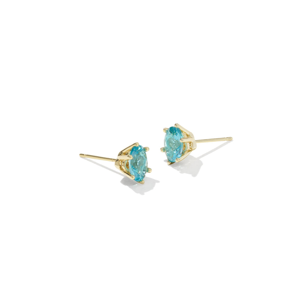 Gold earrings with blue gemstones on a white background