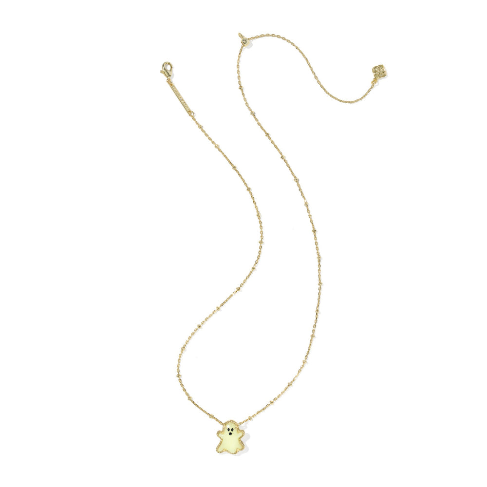 A delicate gold chain necklace featuring a small, pale yellow ghost-shaped pendant with embroidered black eyes and mouth, displayed on a clean white background.