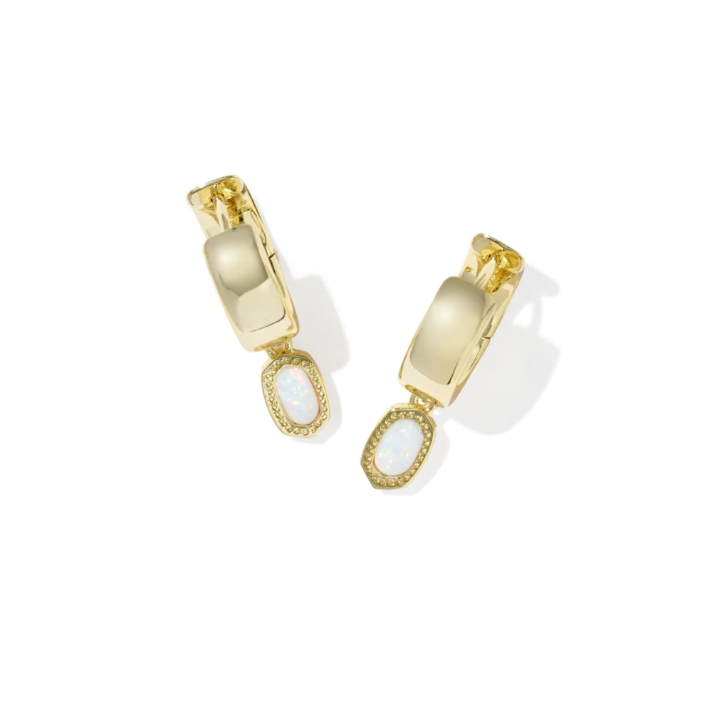 Gold earrings with white stones on a white background