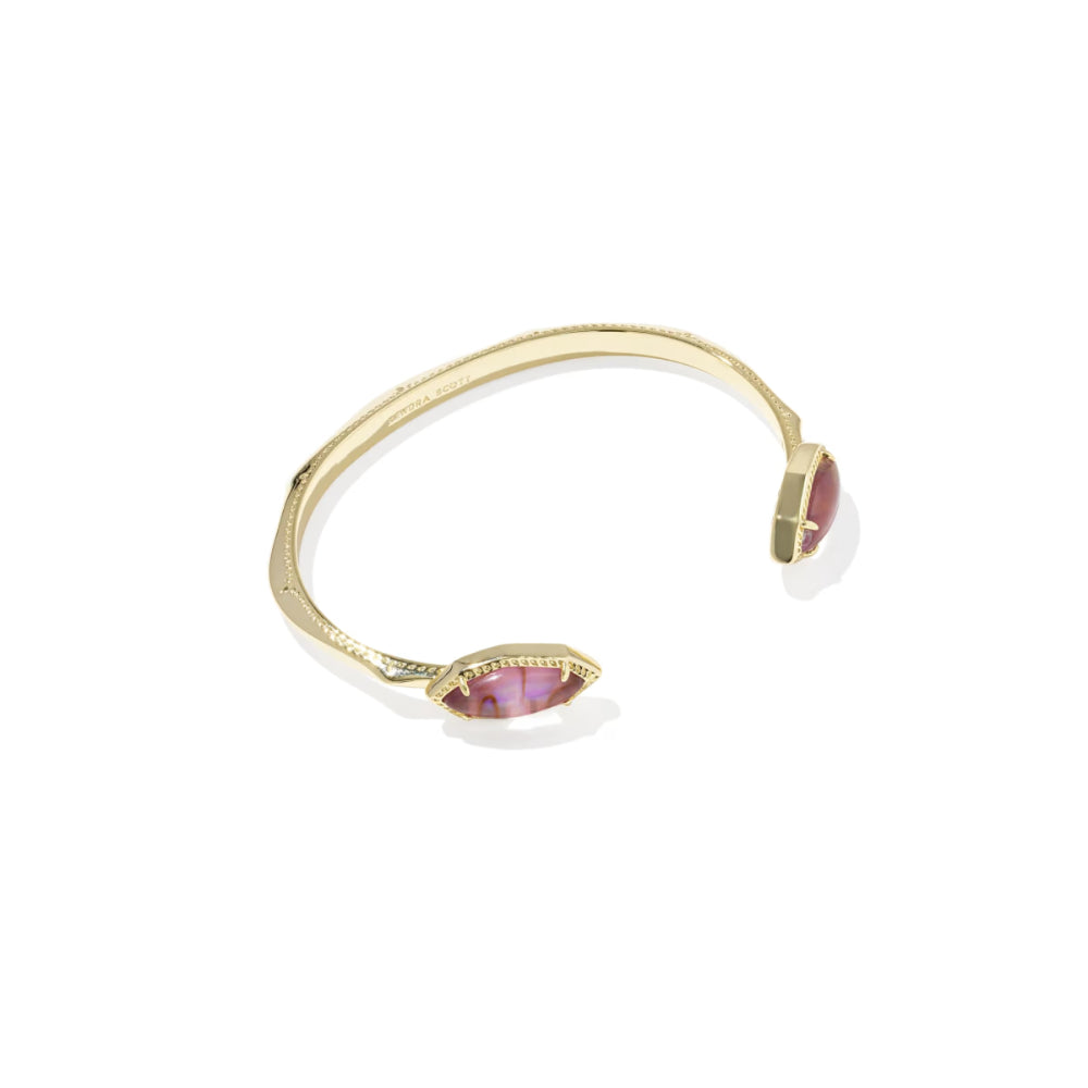 Gold bracelet with pink gemstones on a white background