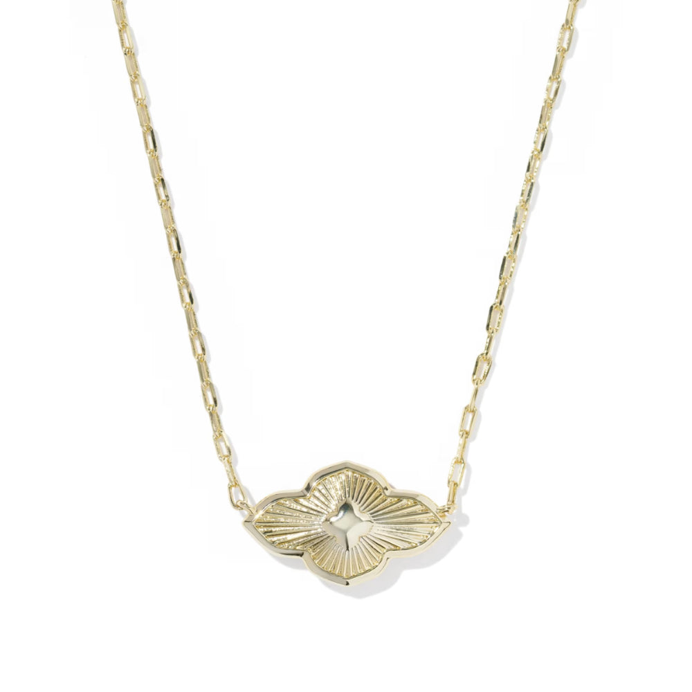 Gold necklace with a leaf-shaped pendant on a white background