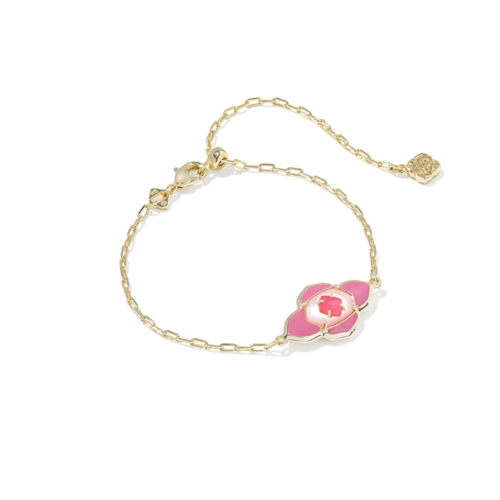 Gold bracelet with a pink flower charm on a white background
