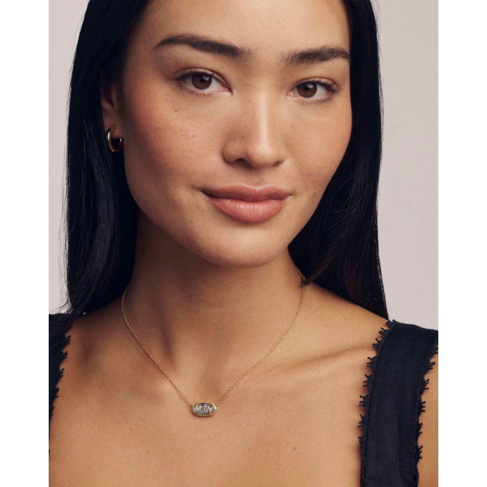 Woman wearing a delicate necklace against a neutral background